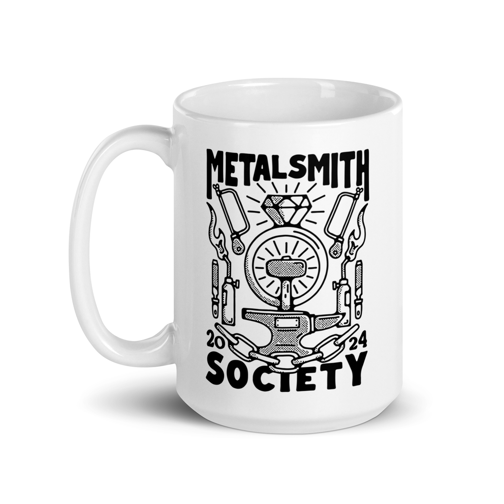 This white mug with a black design  features the limited edition 2024 design created by Boring friends for Metalsmith Society. It depicts jewelry making tools!